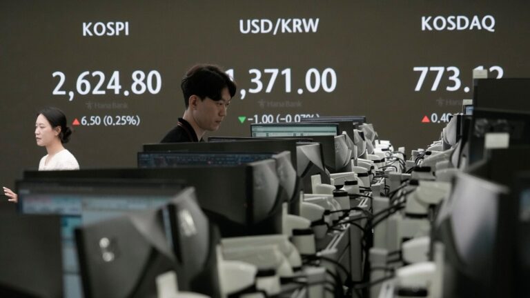 Asian shares trade mixed as Japan and other markets calm from a previous week of crazy swings