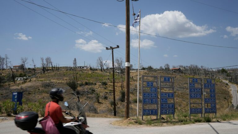 AP PHOTOS: A ferocious blaze scars the land outside Greece’s capital